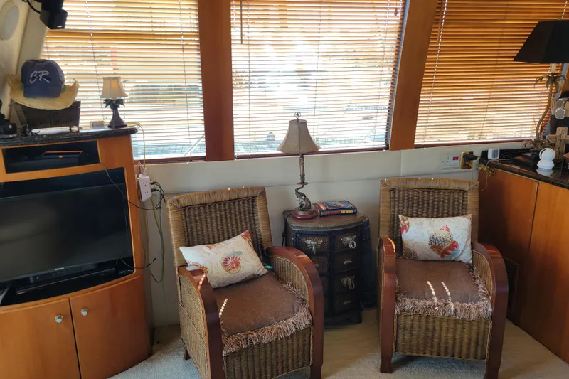 Slide: The Image of Interior of 2001 Carver 570 Voyager Pilothouse with wicker chairs and wooden blinds. - 18