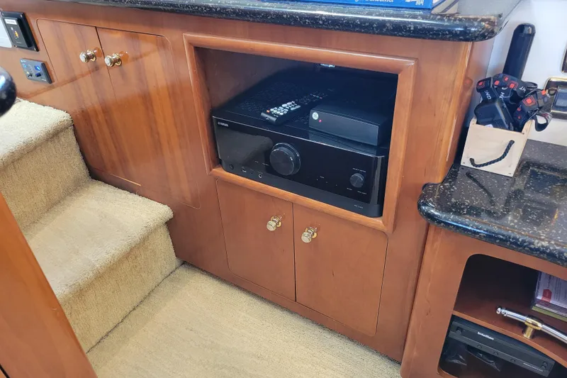 Slide: The Image of Interior of 2001 Carver 570 Voyager Pilothouse with wooden cabinetry and electronic equipment. - 20