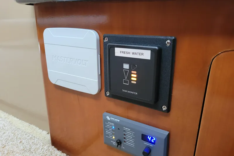 Slide: The Image of Control panel on 2001 Carver 570 Voyager Pilothouse, featuring fresh water tank monitor. - 21