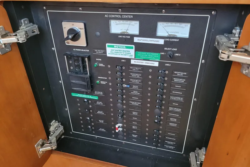 Slide: The Image of AC control panel of 2001 Carver 570 Voyager Pilothouse with switches and meters. - 27