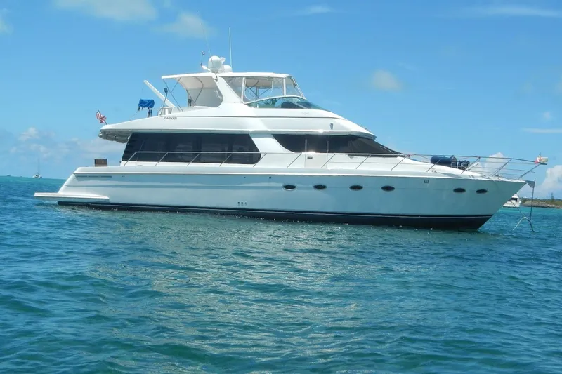 Slide: The Image of 2001 Carver 570 Voyager Pilothouse yacht on blue ocean water. - 28