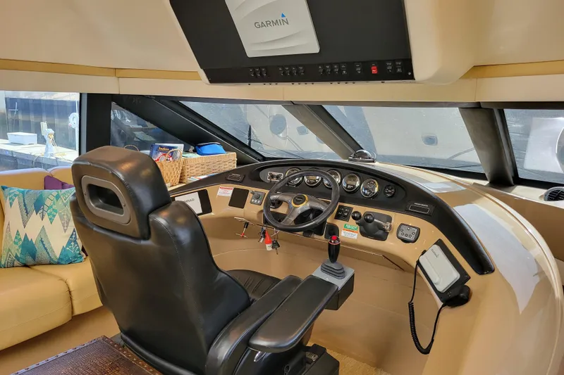 Slide: The Image of Interior of 2001 Carver 570 Voyager Pilothouse with steering controls and navigation equipment. - 31
