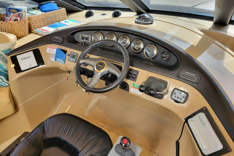 Slide: The Image of Pilothouse interior of 2001 Carver 570 Voyager with steering wheel and navigation instruments. - 32