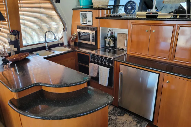 Slide: The Image of Luxurious kitchen interior of 2001 Carver 570 Voyager Pilothouse yacht with modern appliances. - 4