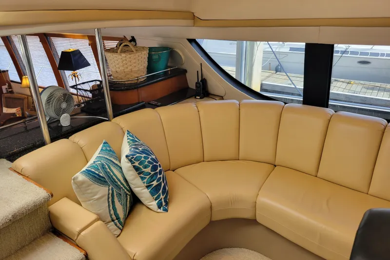 Slide: The Image of Luxurious interior of 2001 Carver 570 Voyager Pilothouse with beige seating and decorative pillows. - 40
