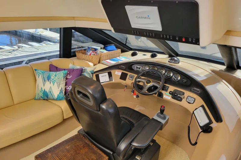 Slide: The Image of Pilothouse interior of 2001 Carver 570 Voyager with helm, seating, and navigation equipment. - 42