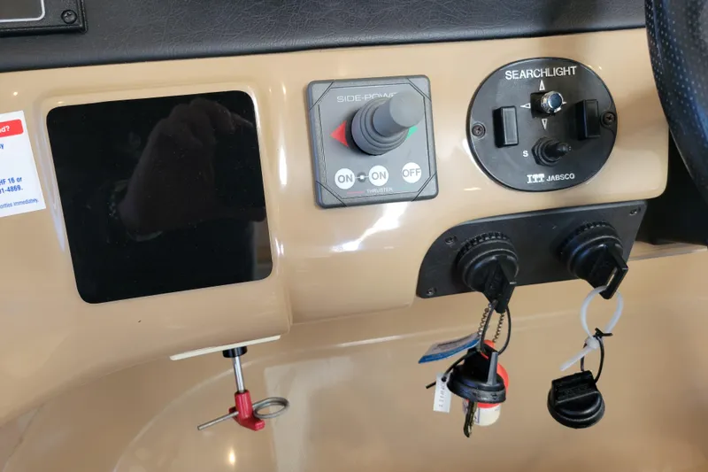 Slide: The Image of Control panel of a 2001 Carver 570 Voyager Pilothouse with searchlight and side-power controls. - 44