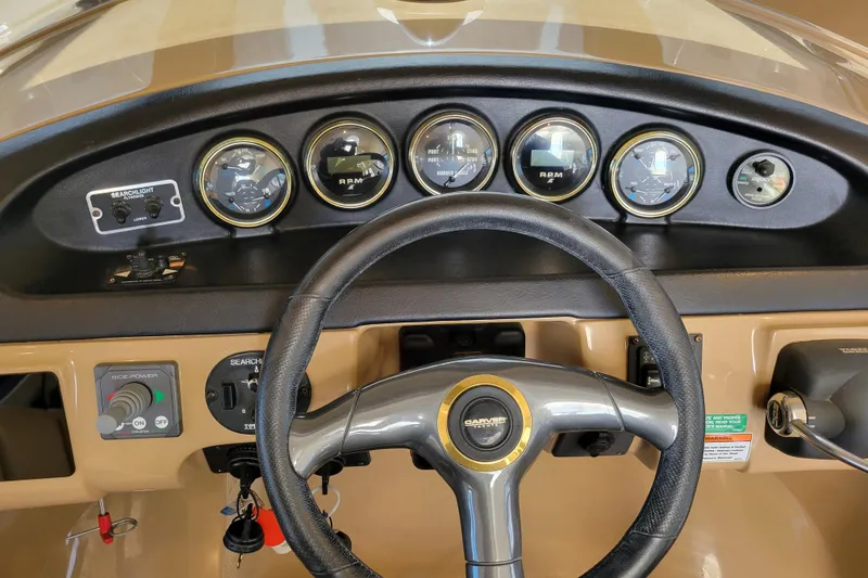 Slide: The Image of Dashboard of 2001 Carver 570 Voyager Pilothouse with gauges and steering wheel. - 45