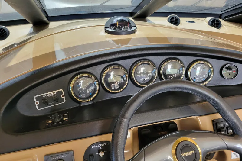 Slide: The Image of Dashboard of 2001 Carver 570 Voyager Pilothouse with gauges and steering wheel. - 46
