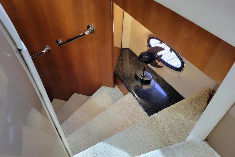 Slide: The Image of Staircase in 2001 Carver 570 Voyager Pilothouse with wooden paneling and decorative lamp. - 49