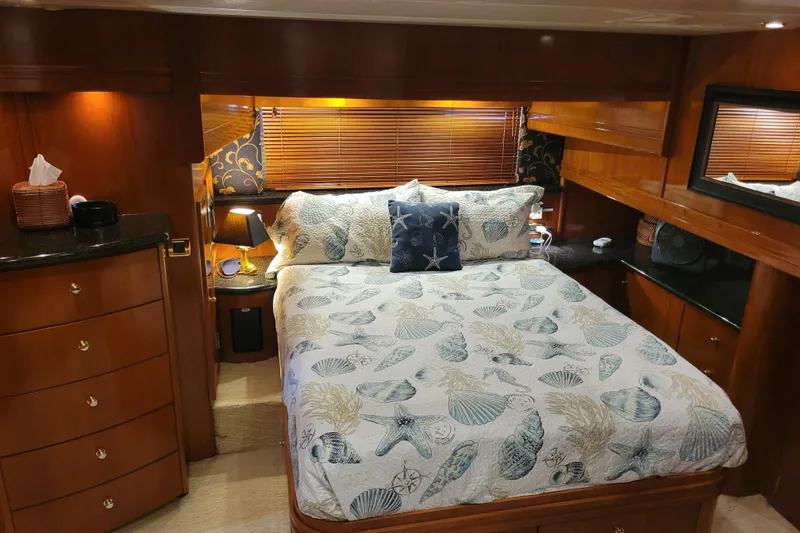 Slide: The Image of Luxurious bedroom interior of 2001 Carver 570 Voyager Pilothouse yacht with elegant wood finishes. - 52