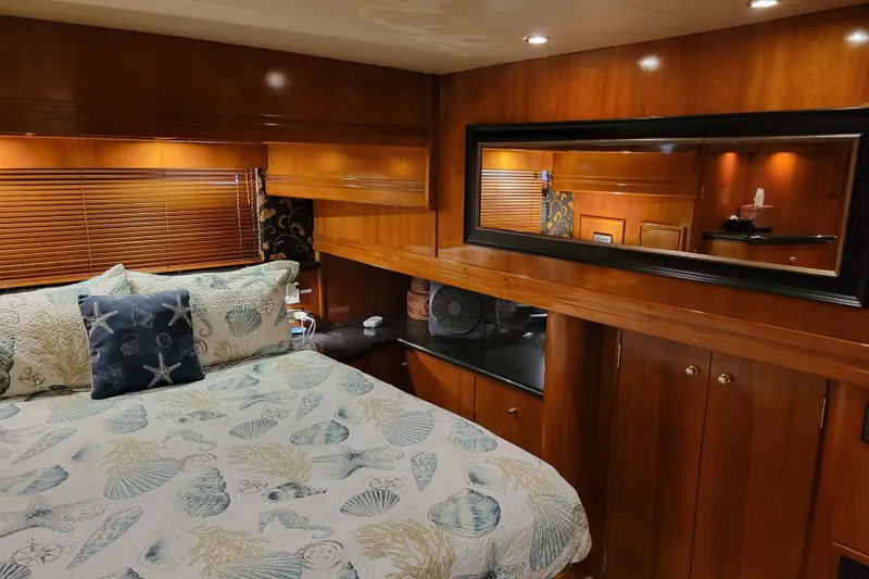 Slide: The Image of Luxurious bedroom interior of 2001 Carver 570 Voyager Pilothouse yacht with elegant wood finish. - 53