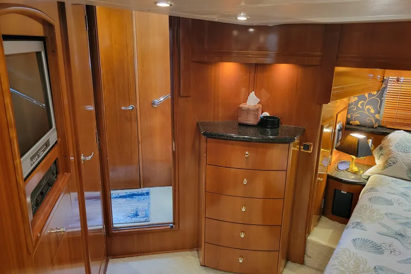 Slide: The Image of Luxurious interior of 2001 Carver 570 Voyager Pilothouse with wood cabinetry and cozy bedroom. - 54