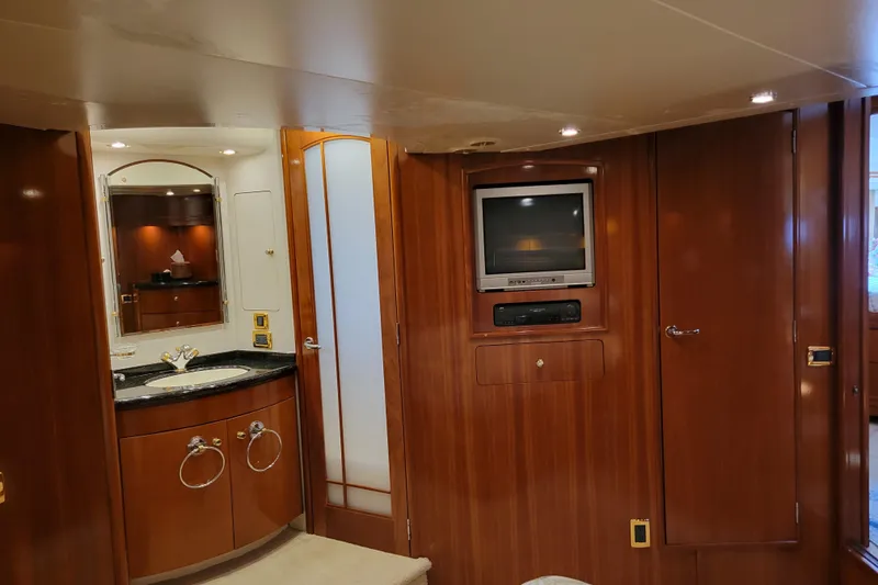 Slide: The Image of Luxurious interior of 2001 Carver 570 Voyager Pilothouse with wood paneling and built-in TV. - 57
