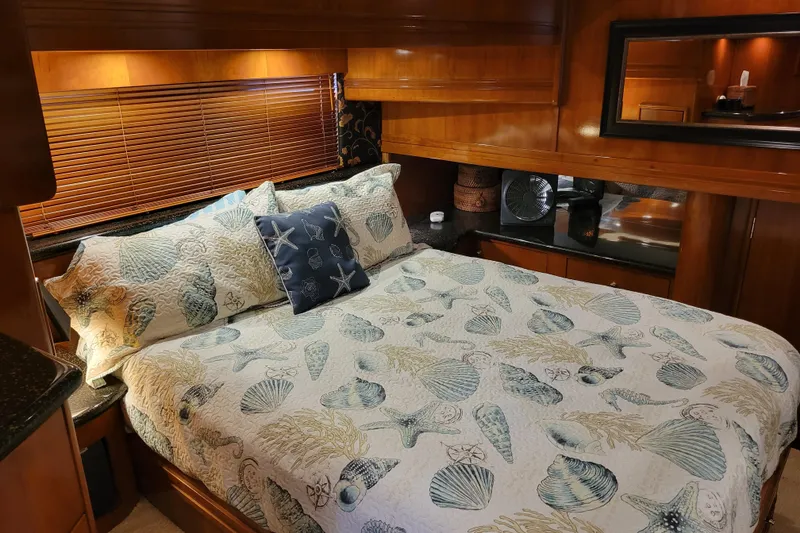 Slide: The Image of Luxurious bedroom interior of 2001 Carver 570 Voyager Pilothouse yacht with seashell-themed bedding. - 59