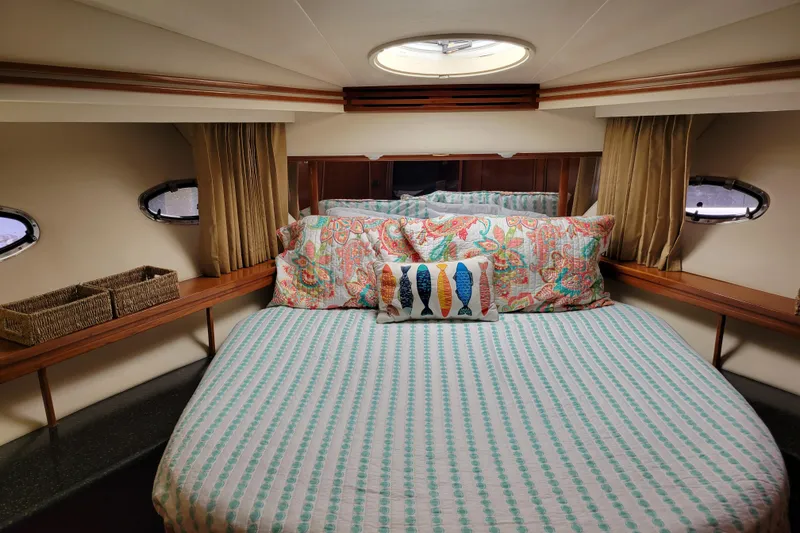Slide: The Image of Luxurious bedroom interior of 2001 Carver 570 Voyager Pilothouse yacht with colorful bedding. - 63