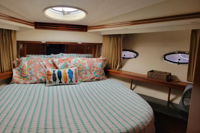 Slide: The Image of Cozy bedroom in 2001 Carver 570 Voyager Pilothouse with colorful bedding and porthole windows. - 65