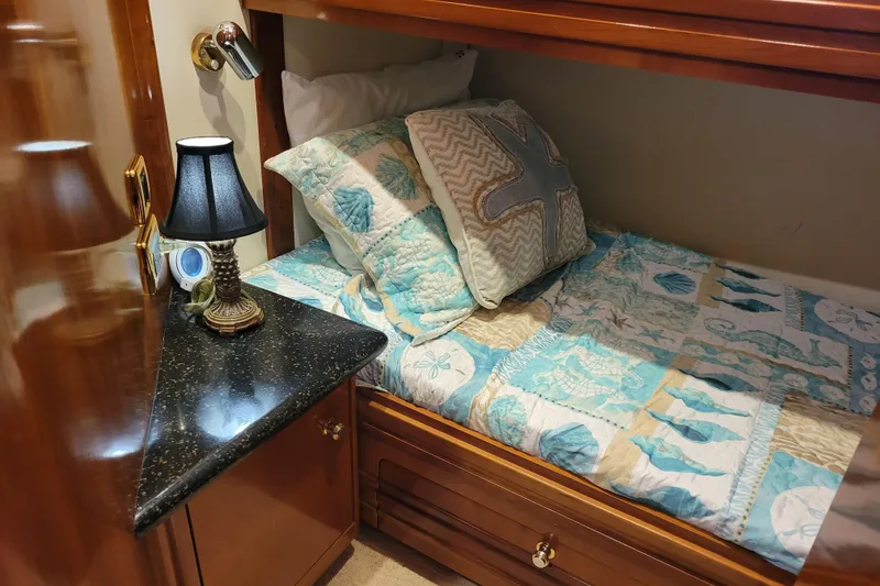 Slide: The Image of Cozy cabin bed with nautical-themed bedding in 2001 Carver 570 Voyager Pilothouse. - 70