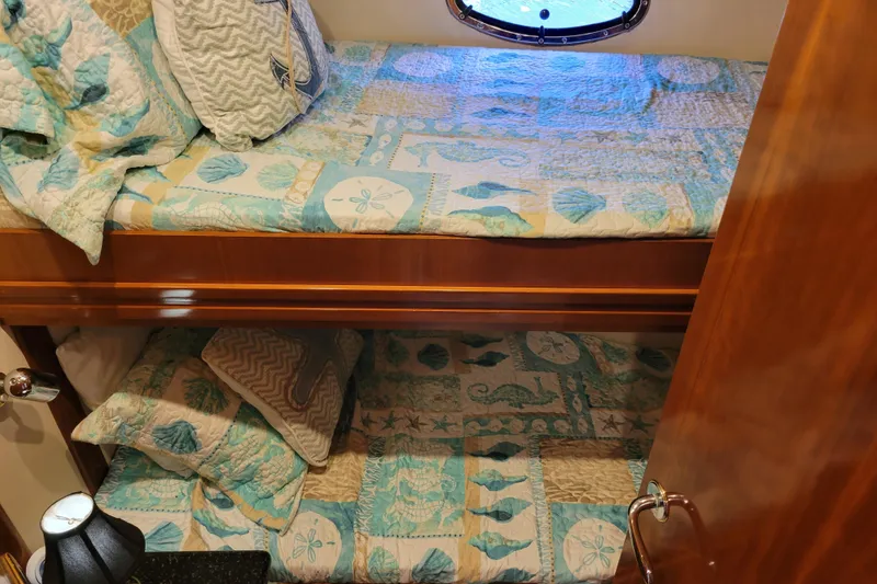 Slide: The Image of Bunk beds with nautical-themed bedding in a 2001 Carver 570 Voyager Pilothouse. - 71