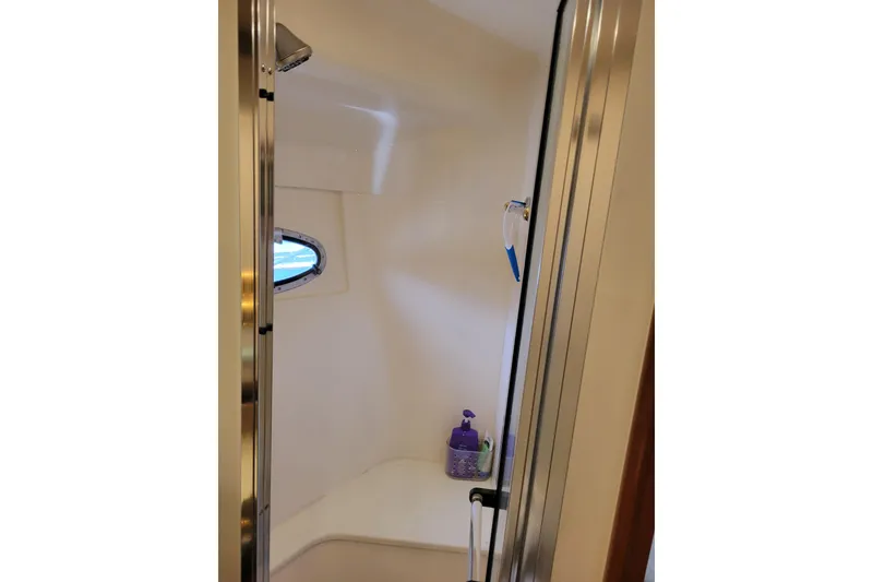 Slide: The Image of Shower area inside 2001 Carver 570 Voyager Pilothouse yacht with window and toiletries. - 74
