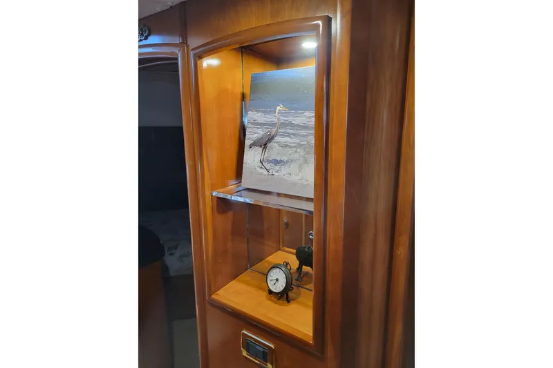 Slide: The Image of Wooden cabinet with heron artwork and clock inside Carver 570 Voyager Pilothouse, 2001 model. - 76