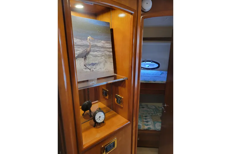 Slide: The Image of Interior of 2001 Carver 570 Voyager Pilothouse with artwork and clock display. - 77