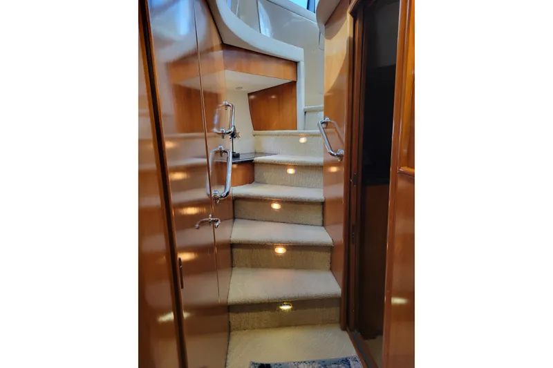Slide: The Image of Interior staircase of 2001 Carver 570 Voyager Pilothouse yacht with wooden finish. - 78