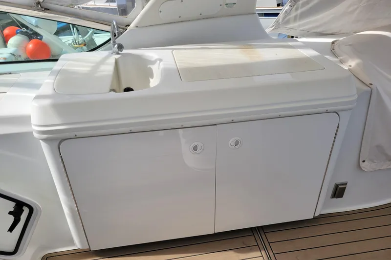 Slide: The Image of Outdoor sink and storage on 2001 Carver 570 Voyager Pilothouse yacht deck. - 82