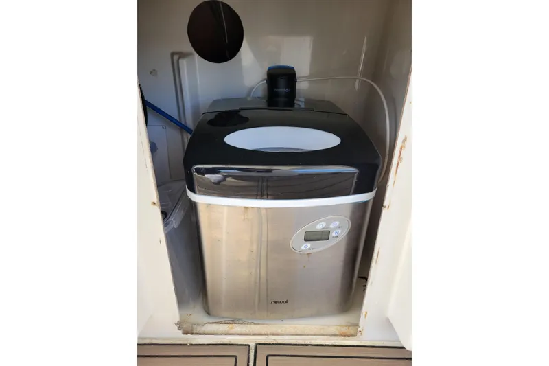 Slide: The Image of Portable ice maker inside 2001 Carver 570 Voyager Pilothouse yacht compartment. - 85