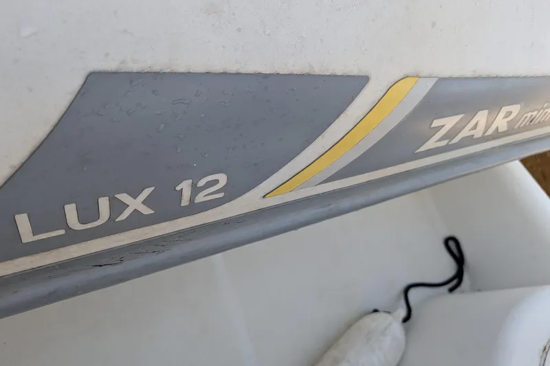 Slide: The Image of Close-up of ZAR mini Lux 12 inflatable boat detail, featuring branding and design elements. - 87