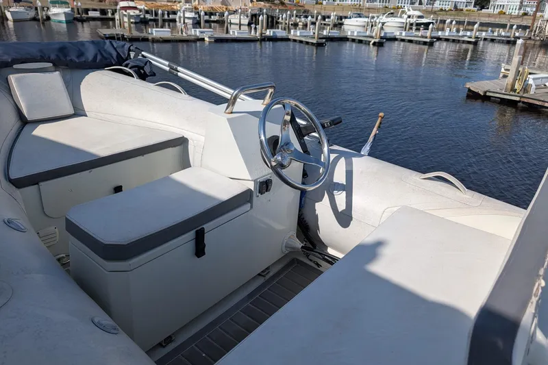 Slide: The Image of 2001 Carver 570 Voyager Pilothouse interior with steering wheel, docked at marina. - 88