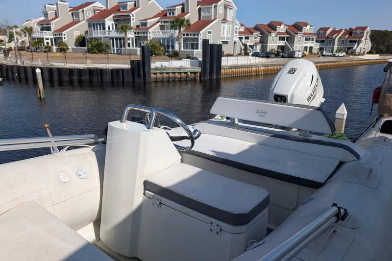 Slide: The Image of 2001 Carver 570 Voyager Pilothouse boat docked near waterfront homes. - 90