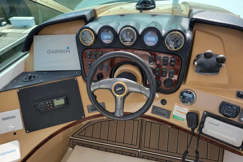 Slide: The Image of 2001 Carver 570 Voyager Pilothouse helm with Garmin navigation and control instruments. - 93