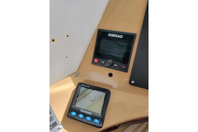 Slide: The Image of Simrad and Navman displays on 2001 Carver 570 Voyager Pilothouse dashboard. - 96