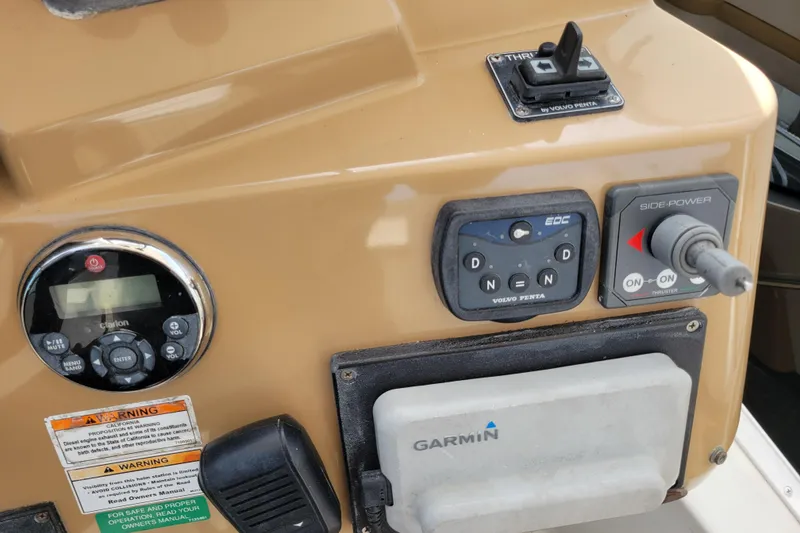 Slide: The Image of Control panel of a 2001 Carver 570 Voyager Pilothouse with Garmin and Volvo Penta systems. - 97