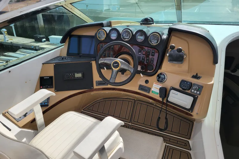 Slide: The Image of 2001 Carver 570 Voyager Pilothouse helm with steering wheel and navigation instruments. - 98