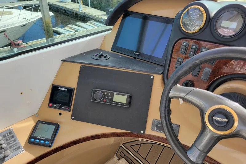 Slide: The Image of 2001 Carver 570 Voyager Pilothouse helm with navigation and control instruments. - 99