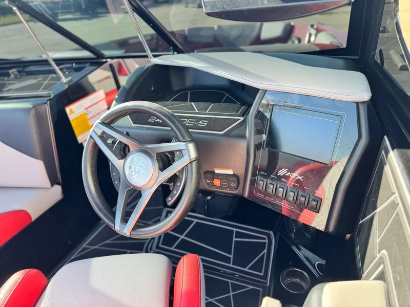 Slide: The Image of Interior of 2022 ATX Surf Boats 24 Type-S with steering wheel and controls. - 14