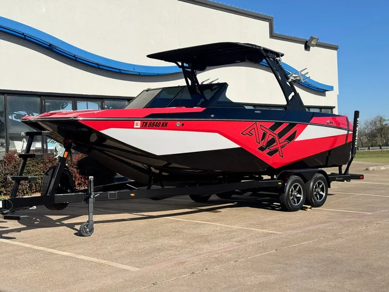 Slide: The Image of 2022 ATX Surf Boats 24 Type-S in red and black on trailer. - 2