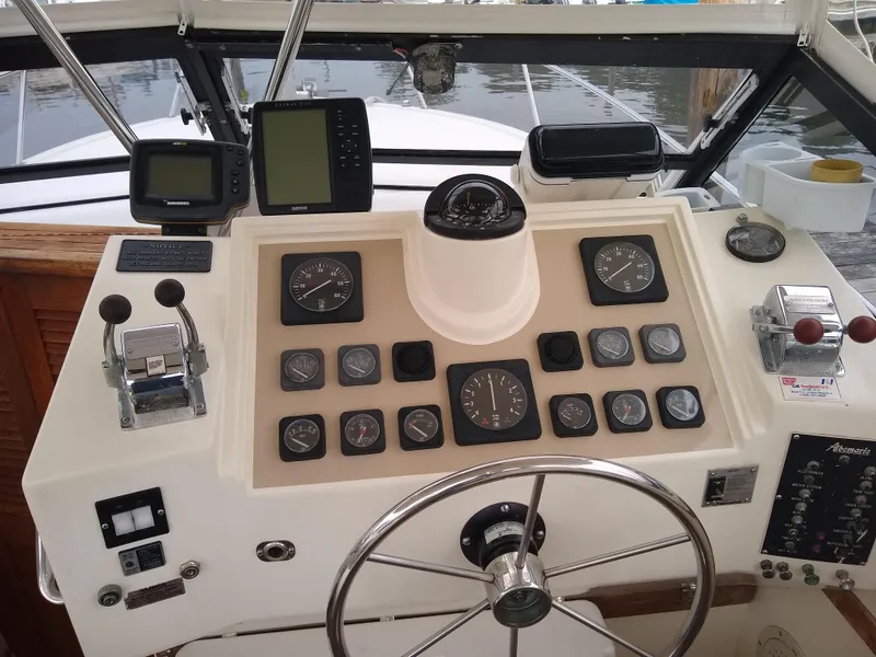 Slide: The Image of Control panel of a 1988 Albemarle 27 Express Fisherman boat with gauges and steering wheel. - 11