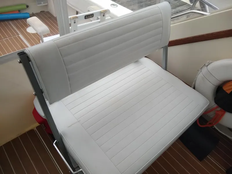 Slide: The Image of 1988 Albemarle 27 Express Fisherman boat interior with white cushioned seating. - 20
