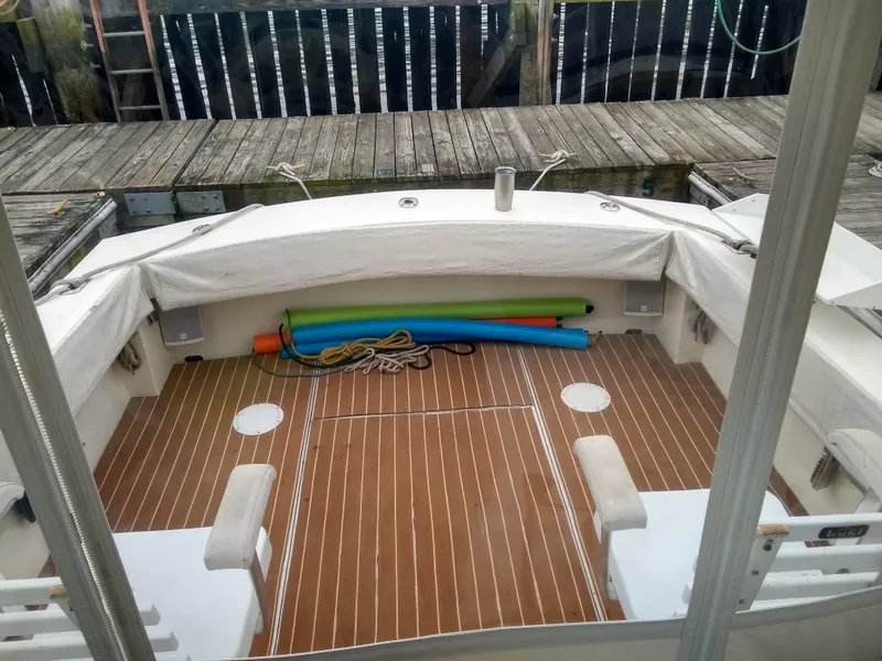 Slide: The Image of 1988 Albemarle 27 Express Fisherman boat with wooden deck and colorful pool noodles. - 21
