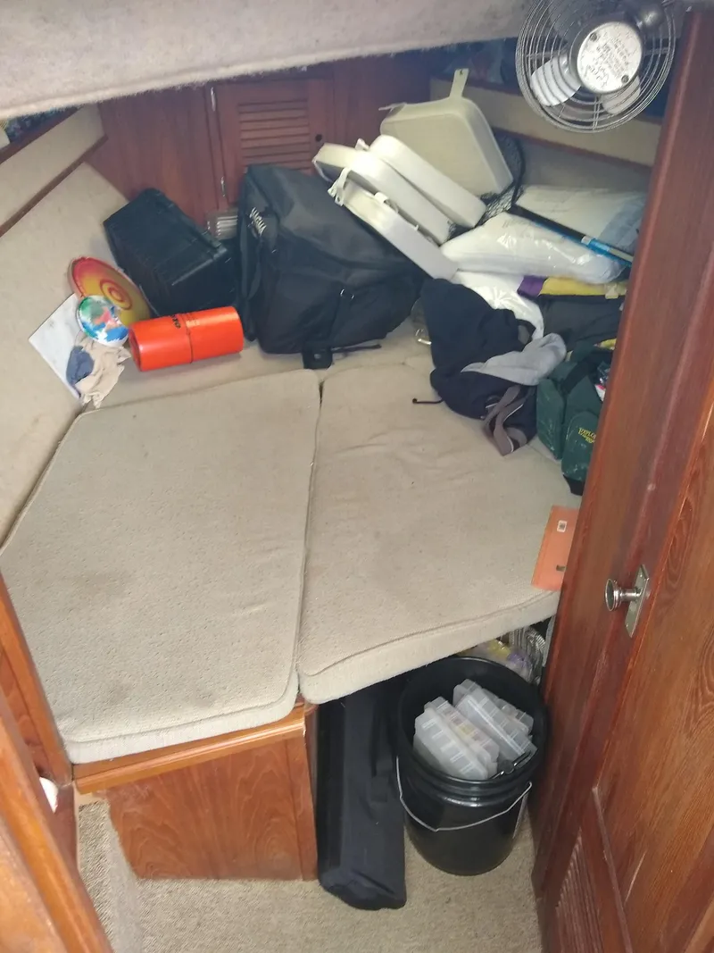 Slide: The Image of 1988 Albemarle 27 Express Fisherman cabin with storage items and seating area. - 23