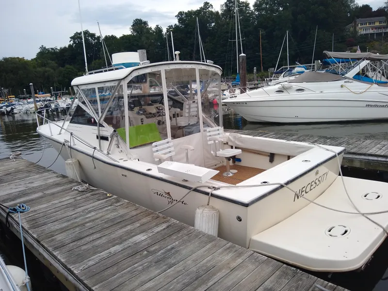 Slide: The Image of 1988 Albemarle 27 Express Fisherman boat docked at marina, surrounded by other boats. - 3