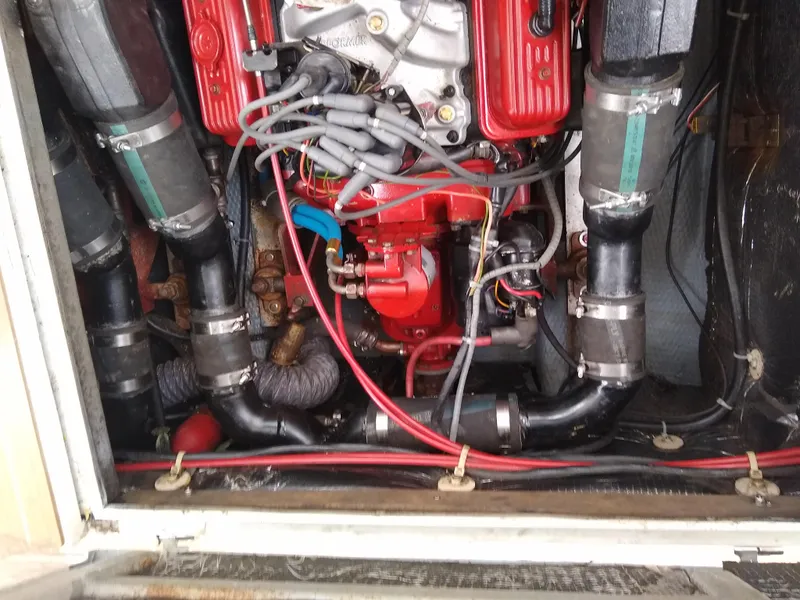 Slide: The Image of Engine compartment of a 1988 Albemarle 27 Express Fisherman boat, showcasing red engine components. - 30