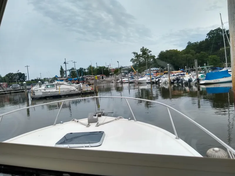 Slide: The Image of 1988 Albemarle 27 Express Fisherman in a marina, surrounded by boats and calm water. - 32