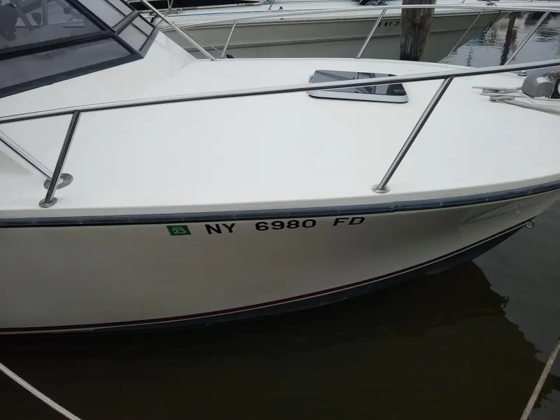 Slide: The Image of 1988 Albemarle 27 Express Fisherman boat docked, displaying registration number NY 6980 FD. - 34