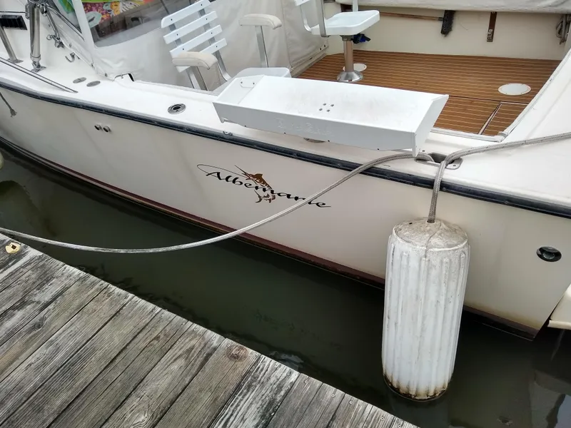 Slide: The Image of 1988 Albemarle 27 Express Fisherman boat docked with visible seating and fender. - 36