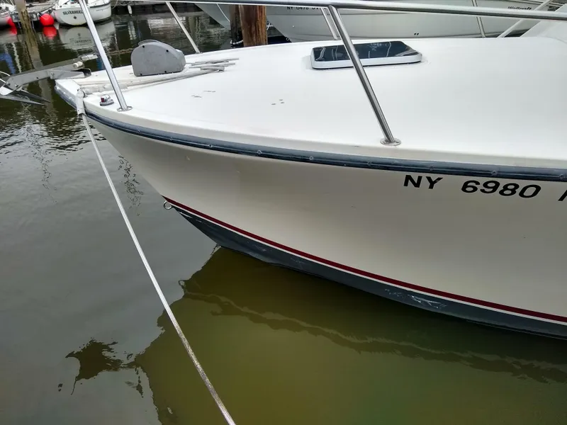 Slide: The Image of 1988 Albemarle 27 Express Fisherman boat docked, showing bow and registration number. - 37