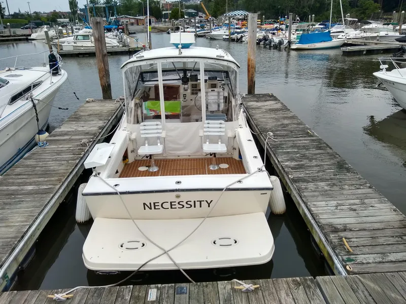 Slide: The Image of 1988 Albemarle 27 Express Fisherman boat named "Necessity" docked at a marina. - 38